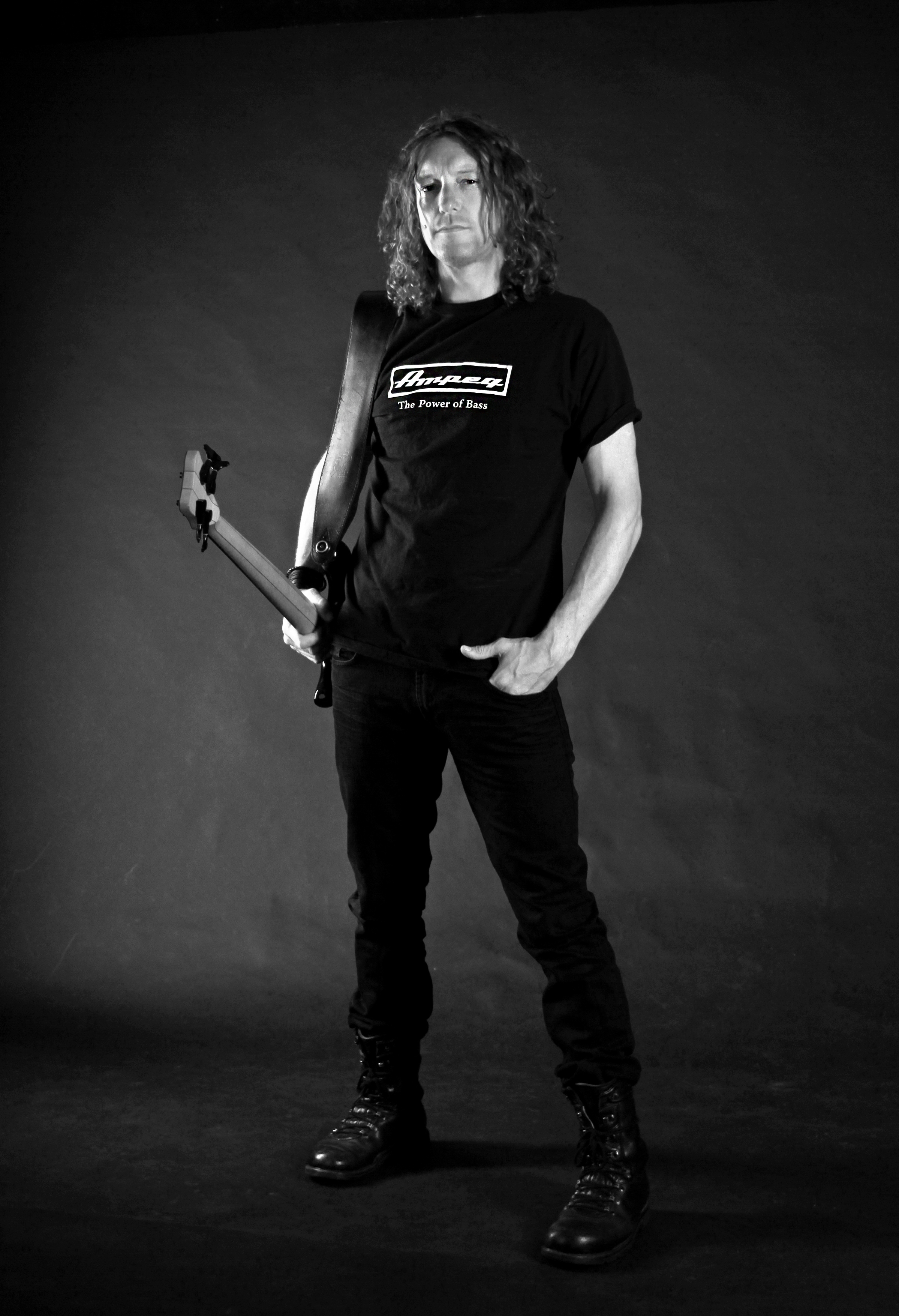 Wayne Banks standing with his bass by his side