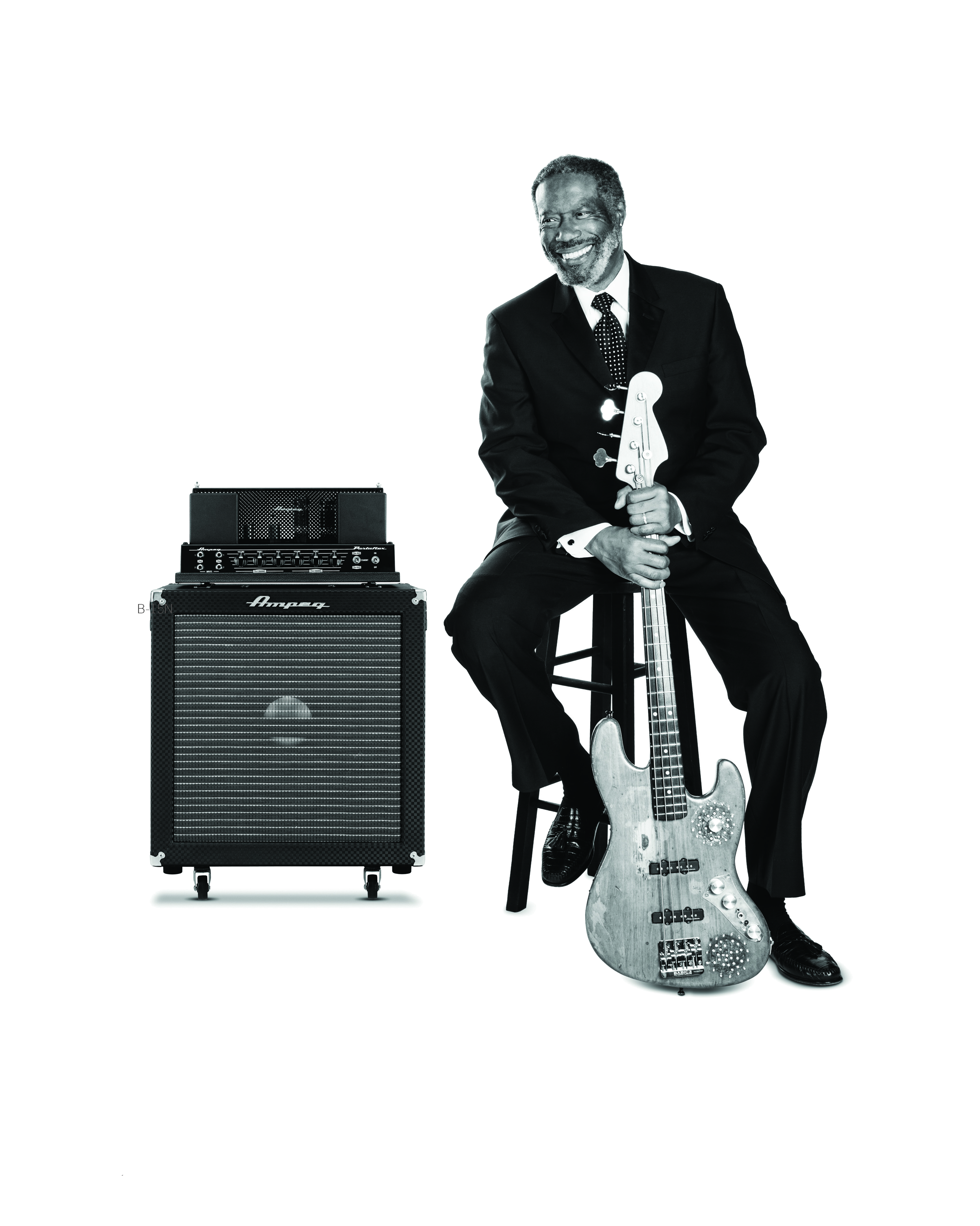 Jerry Jemmott sitting on a stool holding a bass